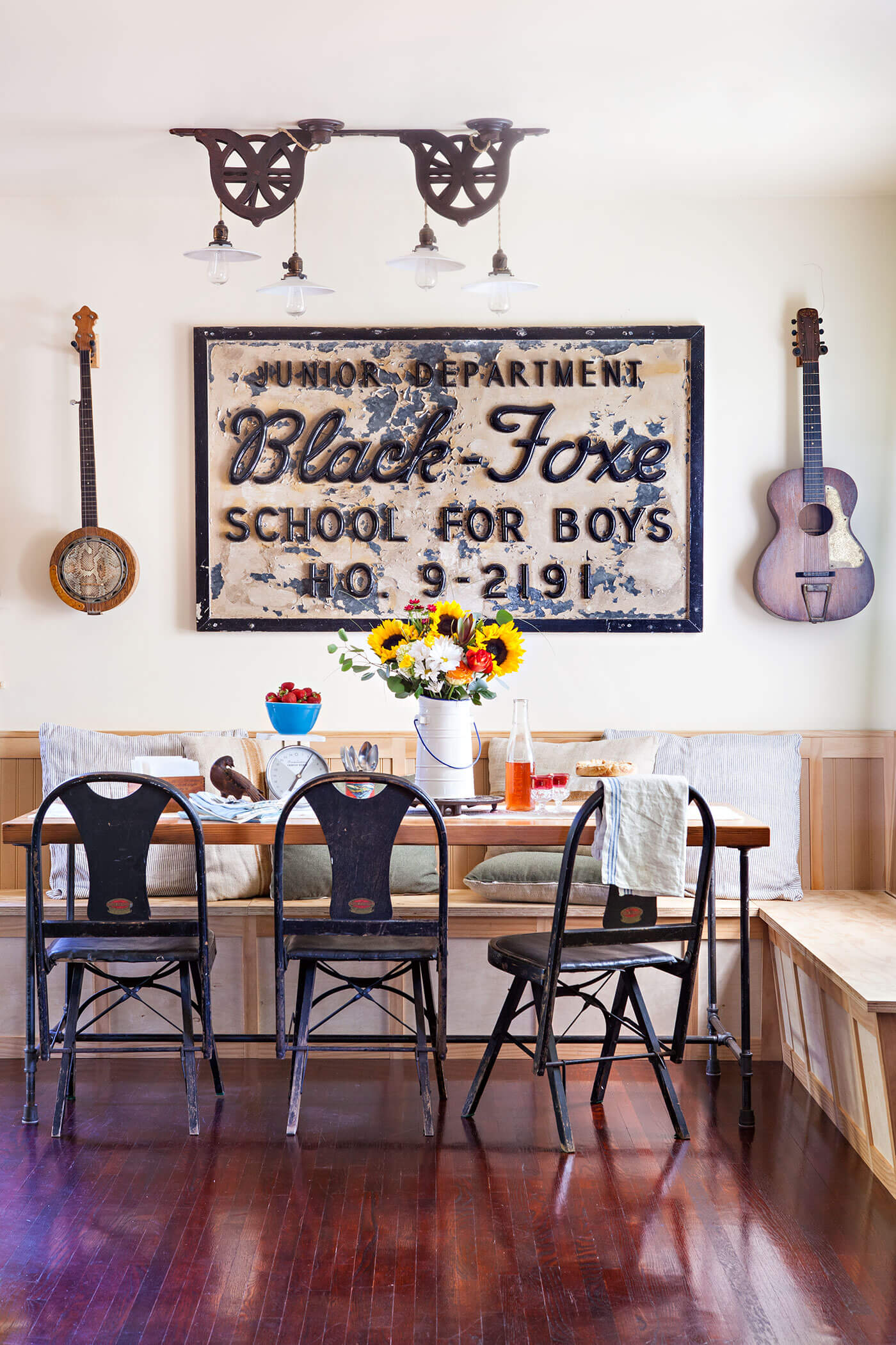 A rustic renovation featuring the dining room composed of antique signage and guitars.