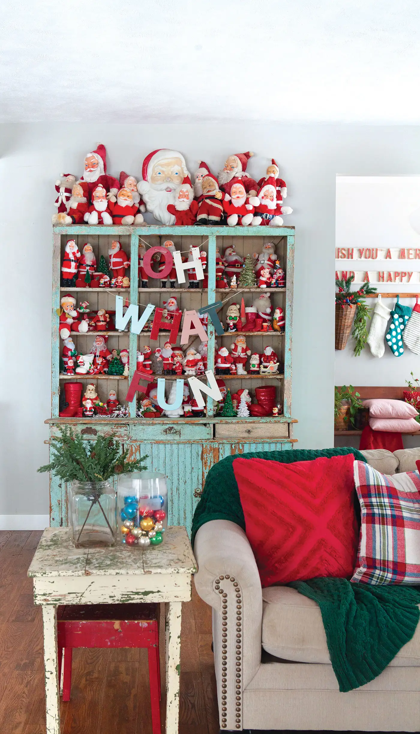 Santa collection in flea market hutch with patina turquoise paint